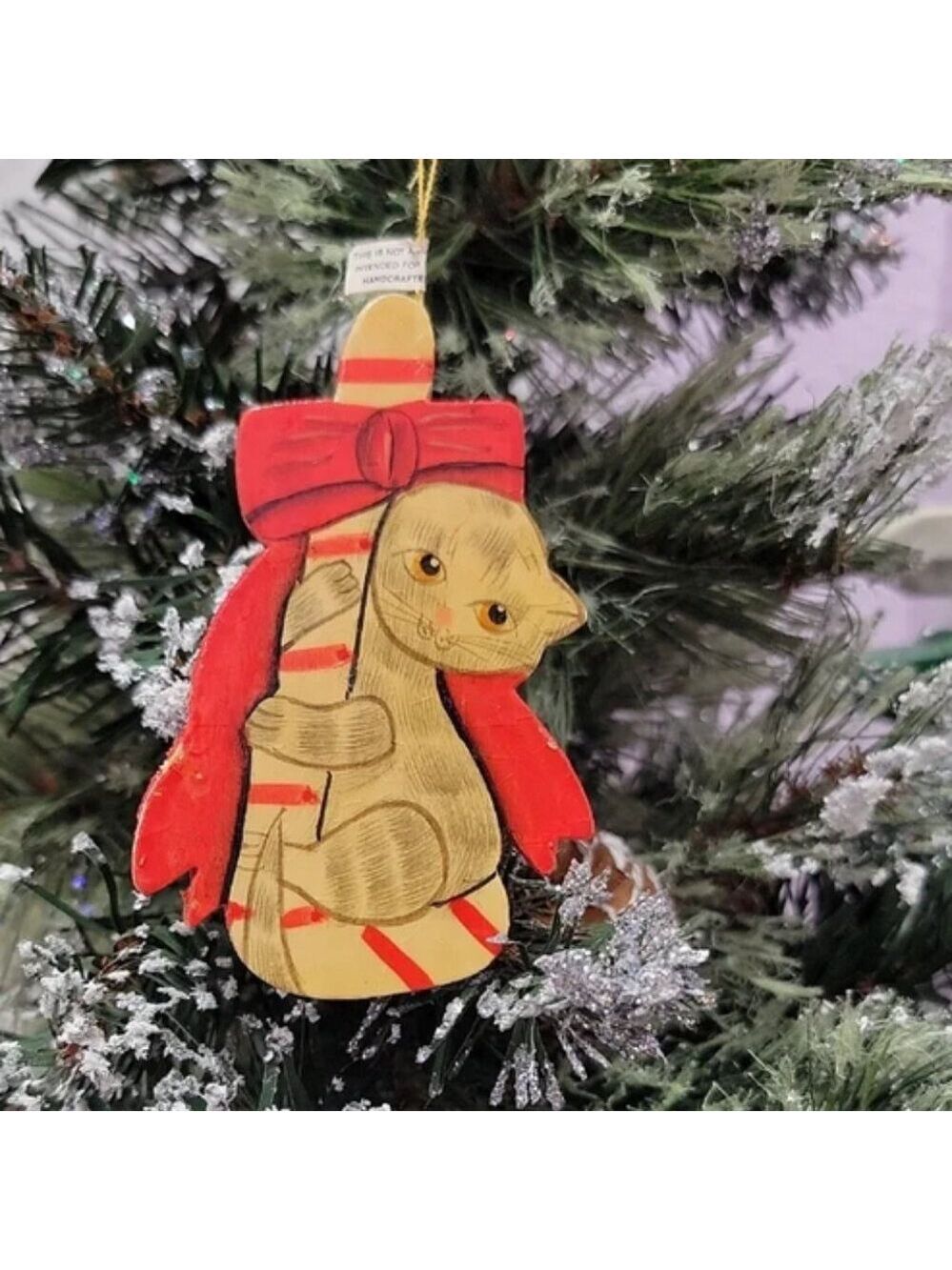 Vintage Kitten holding on to a candy cane Christmas ornament